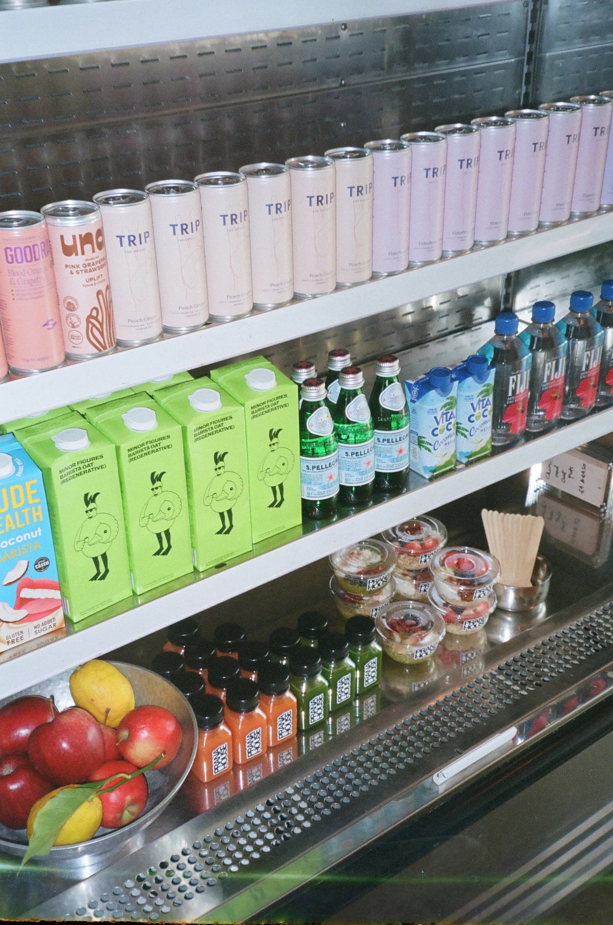 PRANA HOUSE drinks, juices, breakfast pots, and fruit arranged across the counter